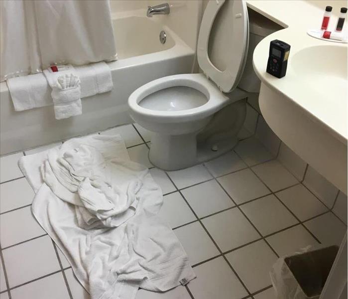 A bathroom with towels on the floor