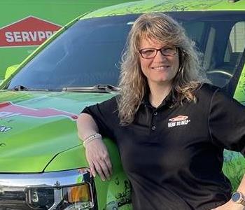 Ginger standing in front of SERVPRO Vehicles 