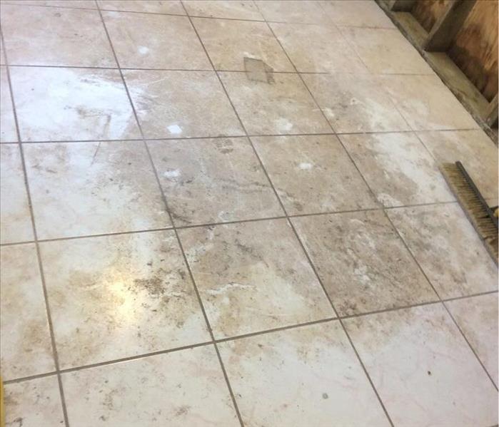 Soil and silt on a tile kitchen floor