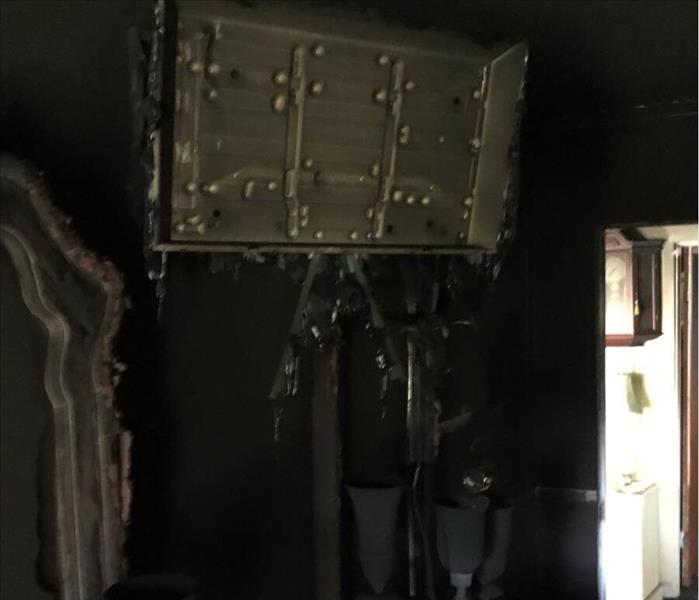 A melted tv hung on the wall